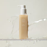 ProtoClinical k-beauty tall beige skincare product centered on a pale blue and cream background.