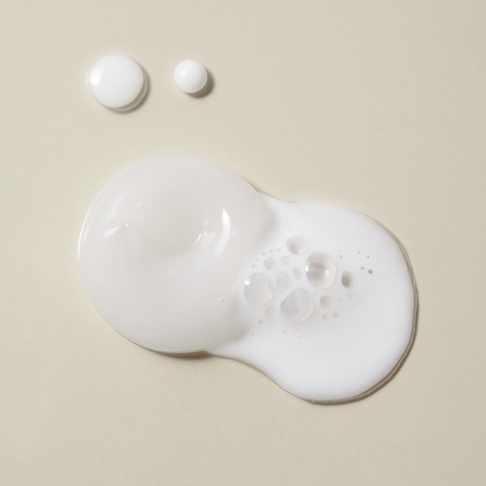 ProtoClinical k-beauty pale beige beauty graphic with a muted lavender gray center on a light background.