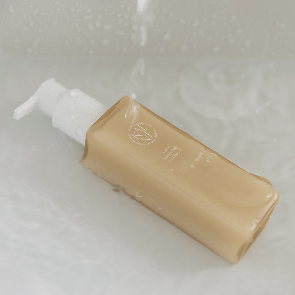 ProtoClinical k-beauty warm brown beauty product centered on a pale blue and gray background.