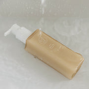 ProtoClinical k-beauty warm brown beauty product centered on a pale blue and gray background.