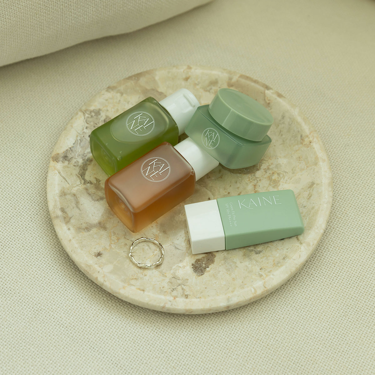 ProtoClinical k-beauty skincare product packaging on a light background.