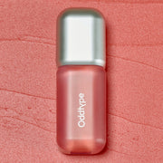 ProtoClinical k-beauty Oddtype Unseen Blur Tint (562, 655, 788) single upright lip tint tube centered on a coral pink background
