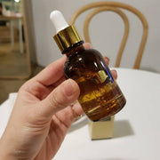 ProtoClinical k-beauty EUNYUL Snail Ampoule 30ml single upright amber-brown ampoule bottle centered on a warm beige background
