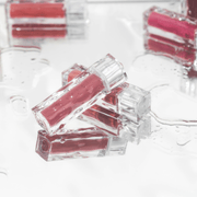 ProtoClinical k-beauty MUZIGAE MANSION Icy Glow 5ml single mauve cylindrical bottle with a dark cap centered on a pale blue and lavender background