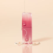 ProtoClinical k-beauty [MACQUEEN New York] Dewy Water Glow Lip Tint 3.5g (9 Color) single berry-red lip tint swatch in a narrow vertical oval on a warm cream and pale yellow background