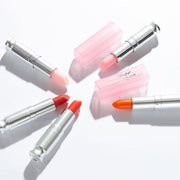 ProtoClinical k-beauty [MACQUEEN New York] Loving You Tint Glow Lip Balm 3.5g (7 Colors) single upright lip balm tube centered on a pale blue and cream background