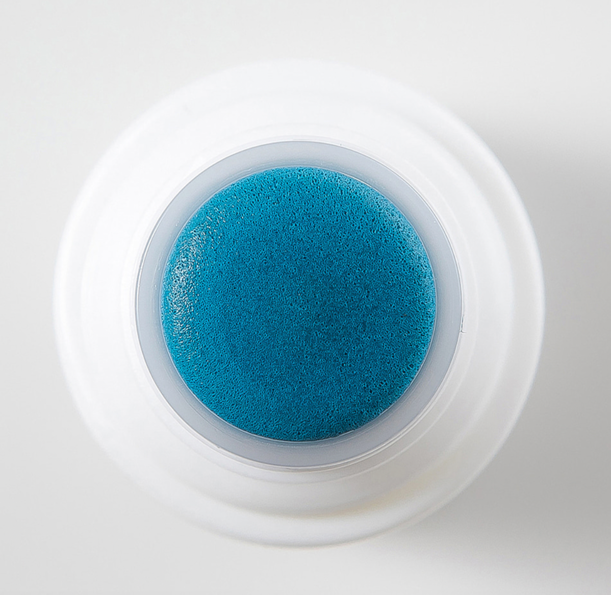 ProtoClinical k-beauty deep blue beauty product silhouette centered on a pale background with soft peach corners.