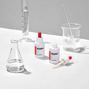 ProtoClinical k-beauty MEDIPEEL Melanon X Ampoule 30ml pale beige ampoule packaging shapes on a light gray background