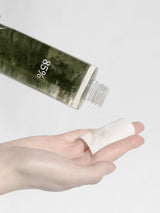 ProtoClinical k-beauty blurred olive and beige beauty graphic with a dark horizontal band, soft blush tones, and pale side highlights on a light background.