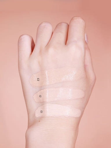 ProtoClinical k-beauty soft peach beauty graphic with a centered pale vertical glow on a warm background.