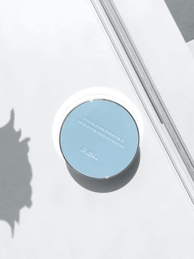 ProtoClinical k-beauty blue and gray beauty graphic with a centered soft-edged form and peach side shading on a light background.