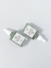 ProtoClinical k-beauty soft gray beauty graphic with a centered horizontal band on a pale background.