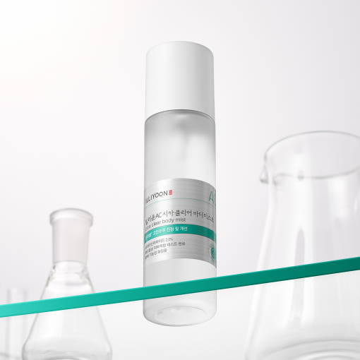 ProtoClinical k-beauty ILLIYOON Cica Trouble Clear Body Mist 200ml shown as a clear bottle with a white cap on a diagonal teal shelf beside glass vessels on a bright white backdrop