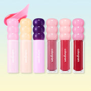 ProtoClinical k-beauty colorgram Fruity Glass Gloss 3g trio of pastel pink lip gloss tubes standing upright with purple, cream, and pink rounded bubble caps on a white background