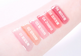 ProtoClinical k-beauty colorgram Fruity Glass Gloss 3g pale pink horizontal gloss swatch with a rose center area and light blue corner on a wide white graphic
