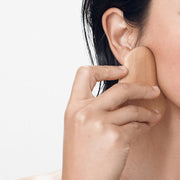 ProtoClinical k-beauty beige beauty product packaging with dark accents on a light background.