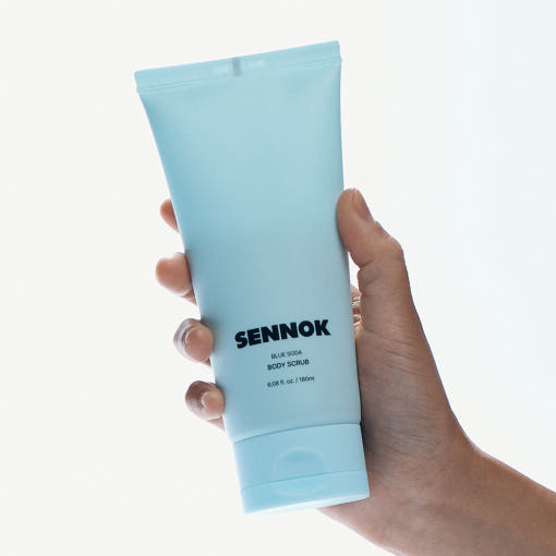 ProtoClinical k-beauty pale blue beauty bottle silhouette with warm peach side tones on a light background.