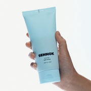 ProtoClinical k-beauty pale blue beauty bottle silhouette with warm peach side tones on a light background.