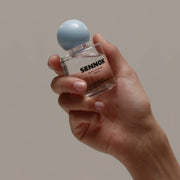 ProtoClinical k-beauty SENNOK Glossy Everyday Hair Oil 60ml single amber hair oil bottle centered on a light background