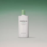 ProtoClinical k-beauty SKIN1004: Madagascar Centella Tea-trica Soothing Sun Milk SPF 50+ Pa (50ml) single pink package silhouette on a white background with deep green upper corners.