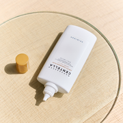 ProtoClinical k-beauty SKIN1004: Madagascar Centella Air-fit Suncream Plus Spf50+ Pa (50ml) single pale cream package silhouette with soft green and blue side accents on a light background.