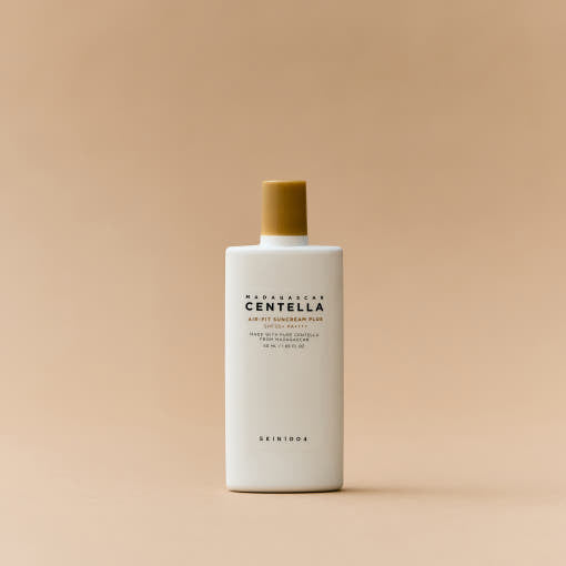ProtoClinical k-beauty SKIN1004: Madagascar Centella Air-fit Suncream Plus Spf50+ Pa (50ml) single warm beige package silhouette with a muted olive center on a light background.