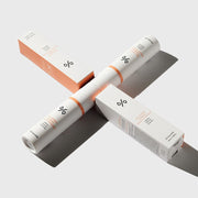 ProtoClinical k-beauty Dr.Ceuracle 5α Control Clearing Serum In Emulsion 100ml white emulsion bottle laid diagonally across two white and coral boxes on a light background with strong shadows