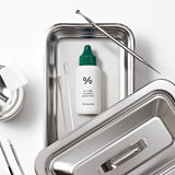 ProtoClinical k-beauty Dr.Ceuracle AC Cure Solution Green Two 50ml single upright bottle centered on a dark green background