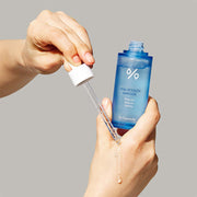 ProtoClinical k-beauty Dr.Ceuracle Hyal Reyouth Ampoule 50ml upright blue dropper bottle on a white background with clear circular serum puddles