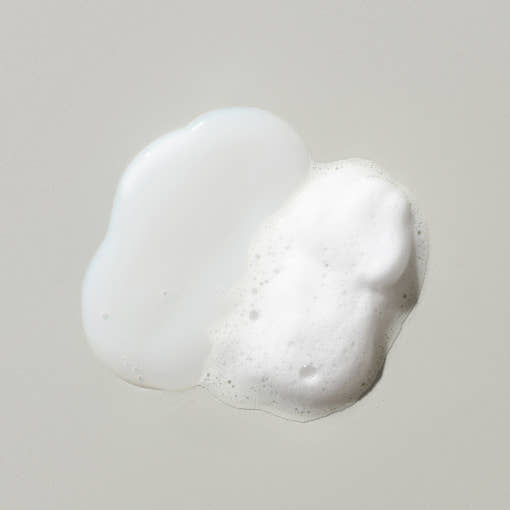 ProtoClinical k-beauty abstract pale gray beauty graphic with a soft cream glow near the center.