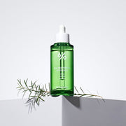 ProtoClinical k-beauty Dr.Ceuracle Tea Tree Purifine 95 Essence 50ml single upright green essence bottle with a darker lower section centered on a white background with soft lavender corner shading