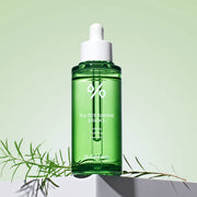 ProtoClinical k-beauty Dr.Ceuracle Tea Tree Purifine 95 Essence 50ml single upright green essence bottle centered on a soft green and blue background