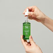 ProtoClinical k-beauty Dr.Ceuracle Tea Tree Purifine 95 Essence 50ml single upright olive green essence carton centered on a pale beige background with soft blue and blush side panels