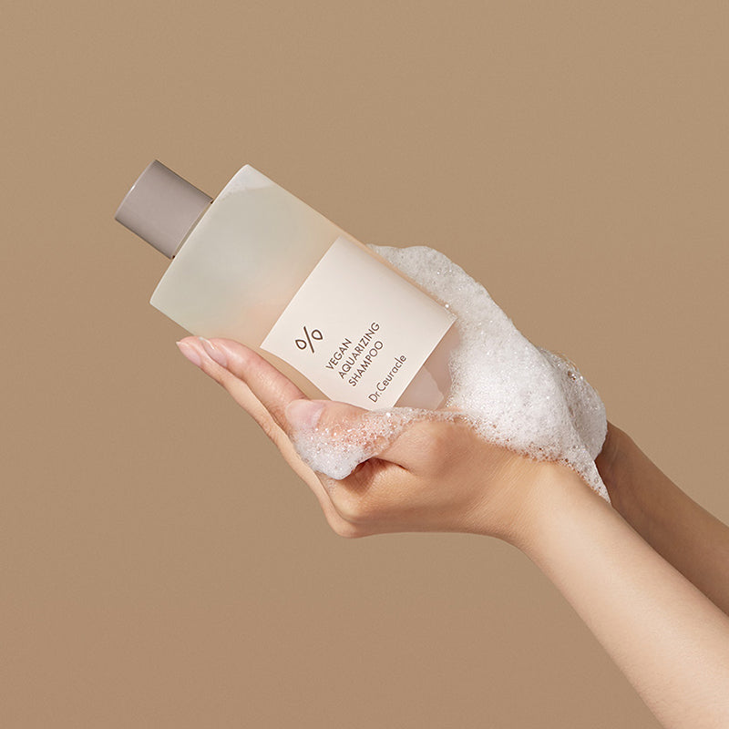 ProtoClinical k-beauty abstract sage, beige, and cream skincare graphic with soft blurred vertical forms on a light background.