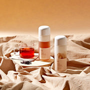 ProtoClinical k-beauty warm beige beauty graphic with a soft horizontal dark band on a light background.