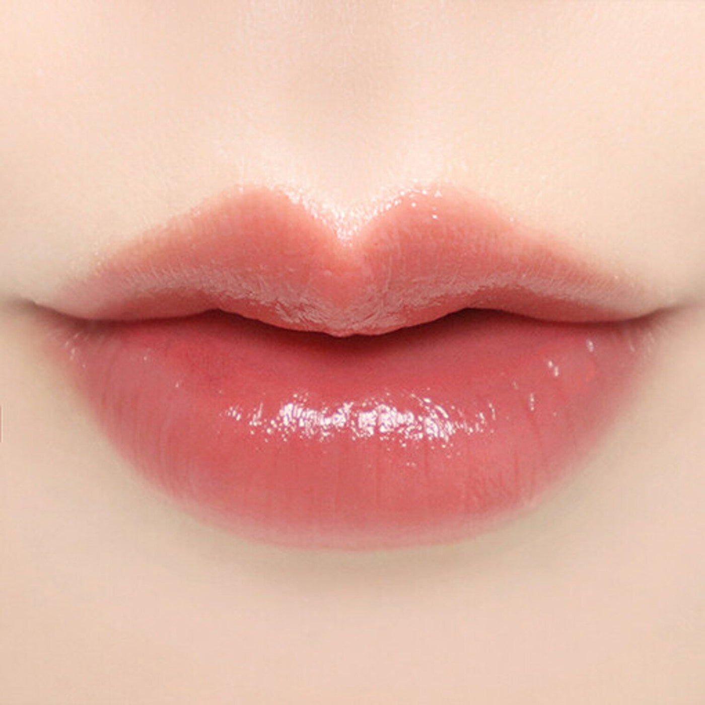 ProtoClinical k-beauty BBIA Ready To Wear Water Lipstick 3g coral-red lipstick swatch stretched horizontally on a pale peach background