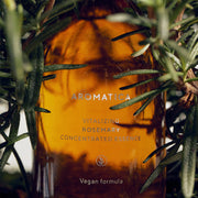ProtoClinical k-beauty AROMATICA Vitalizing Rosemary Concentrated Essence 100ml single upright amber essence bottle centered on a teal and olive background