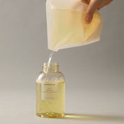 ProtoClinical k-beauty AROMATICA Zesty Hand Soap Grapefruit & Tangerine 300ml (Refill) single upright pale cream hand soap refill package centered on a warm beige background with pale blue side accents.