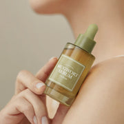 ProtoClinical k-beauty I'm from Mugwort Serum 30ml single upright olive serum bottle centered on a beige background with soft peach side shading