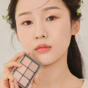 ProtoClinical k-beauty Dinto Blur-Finish Shadow 5.4g #704 Louisa May Alcott close-up makeup look on a woman with warm taupe eyeshadow, a neutral lip, and soft peach skin tones