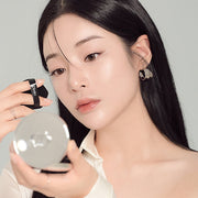 ProtoClinical k-beauty peach-beige vertical beauty product with muted green side panels on a light background.
