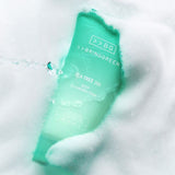 ProtoClinical k-beauty BRINGGREEN Tea Tree Cica Deep Cleansing Foam 120ml single upright mint-green cleansing foam package centered on a pale pink and gray background.