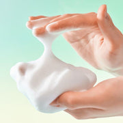 ProtoClinical k-beauty BRINGGREEN Tea Tree Cica Deep Cleansing Foam 120ml shown as dense white foam stretched between two hands on a mint green background