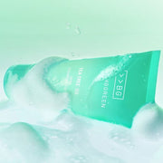 ProtoClinical k-beauty BRINGGREEN Tea Tree Cica Deep Cleansing Foam 120ml mint-green cleanser tube lying sideways in white foam on a pale mint background