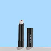 ProtoClinical k-beauty moremo For Men Hidden Color Lip Balm B 3g single upright dark blue lip balm tube centered on a pale blue gradient background