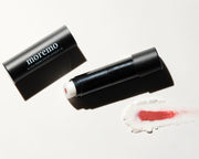 ProtoClinical k-beauty moremo For Men Hidden Color Lip Balm B 3g single dark blue lip balm tube in a horizontal product layout on a pale blue gradient background