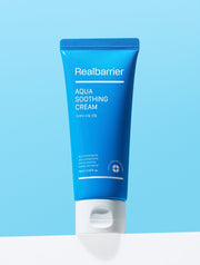 ProtoClinical k-beauty [Real Barrier] Aqua Soothing Cream [Tube] 75ml shown as a single bright blue tube centered on a pale aqua background with soft white areas at the top and bottom