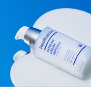 ProtoClinical k-beauty abstract beauty graphic with a bright white upper center on a vivid blue background and soft peach lower tones.