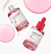 ProtoClinical k-beauty MEDICUBE: Txa Niacinamide 15% Serum (30ml) single upright pale pink serum bottle centered on a light background