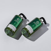 ProtoClinical k-beauty [Daeng Gi Meo Ri] Mugwort Relaxing Shampoo 500ml in a close-up crop with a centered dark green vertical form on a pale olive background